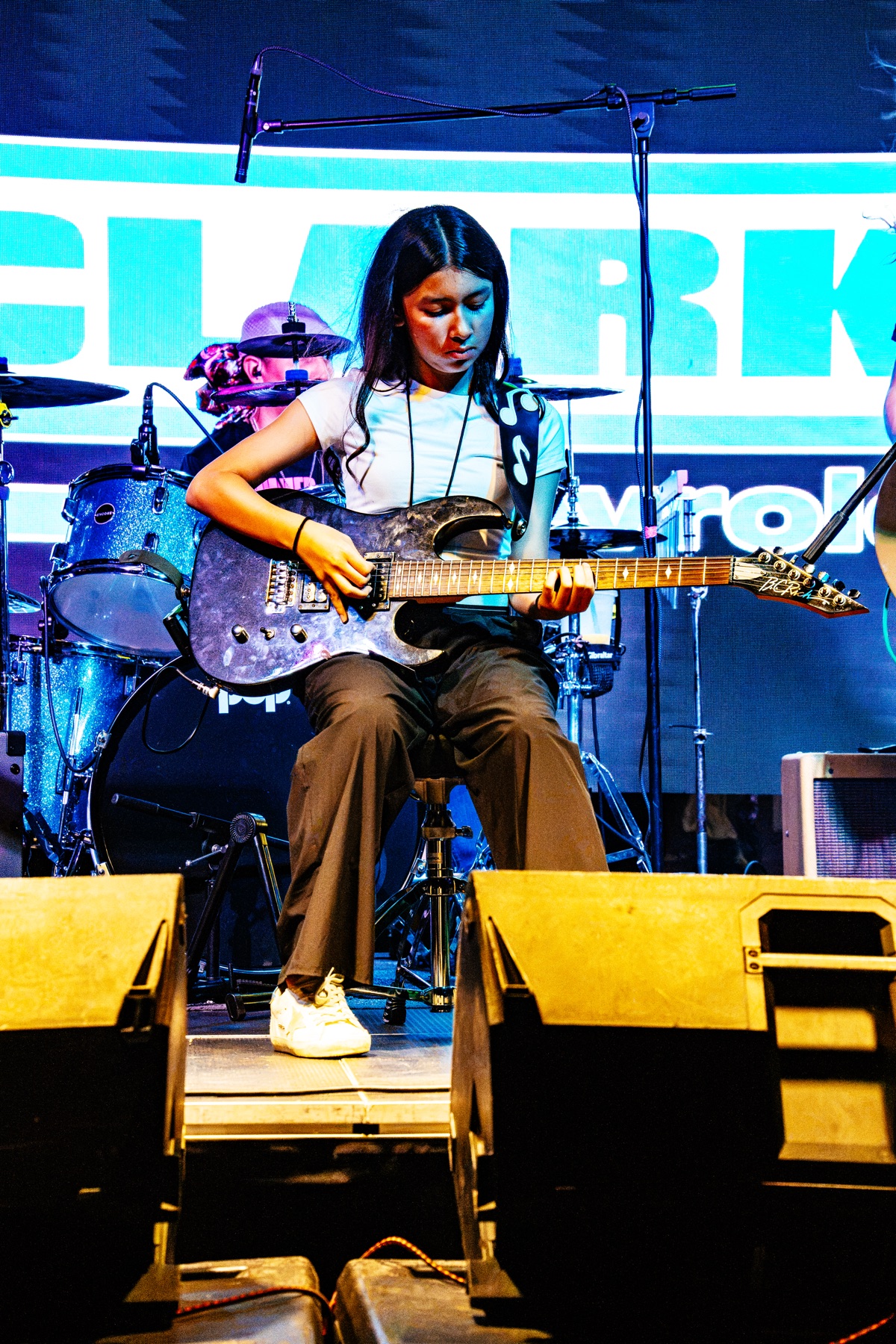 Aaralyn Salinas performing electric guitar on the 2026 festival stage