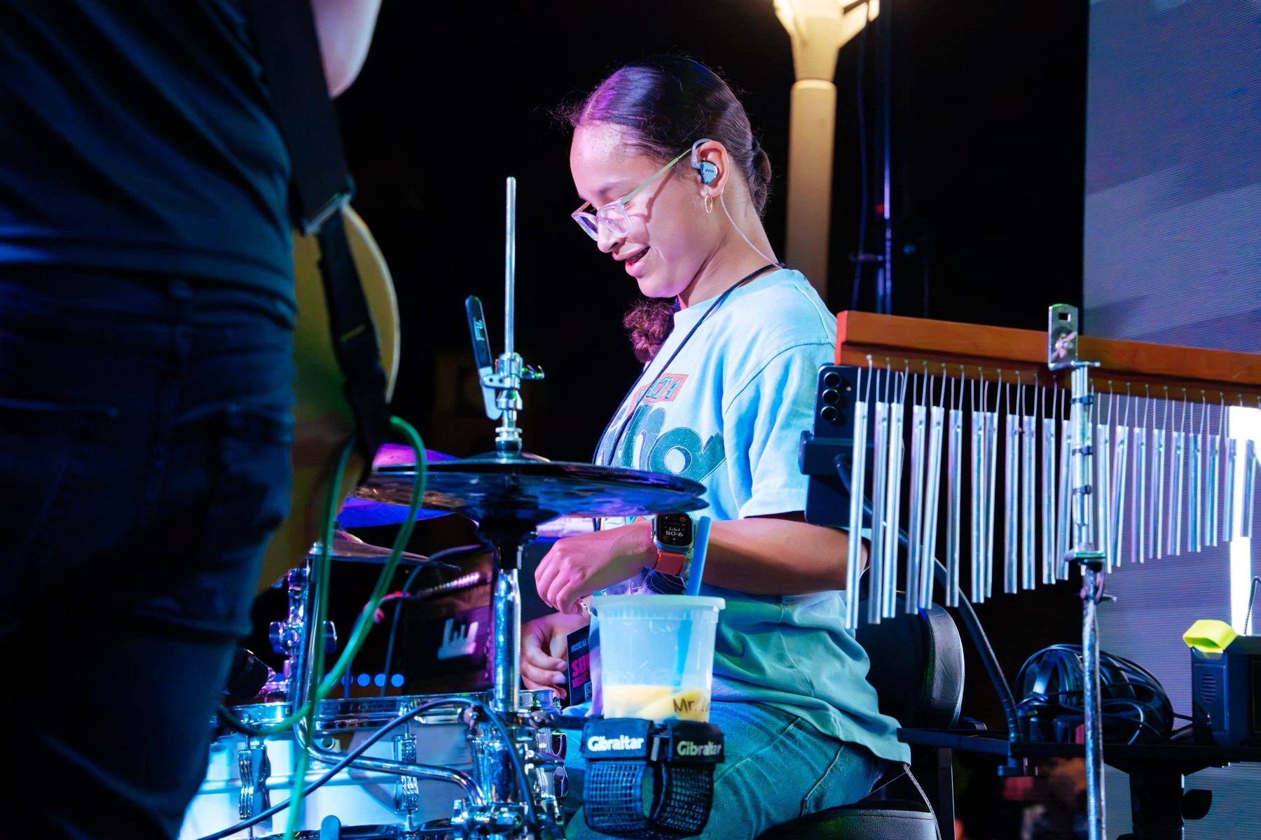 Belen Ceres smiling while performing percussion