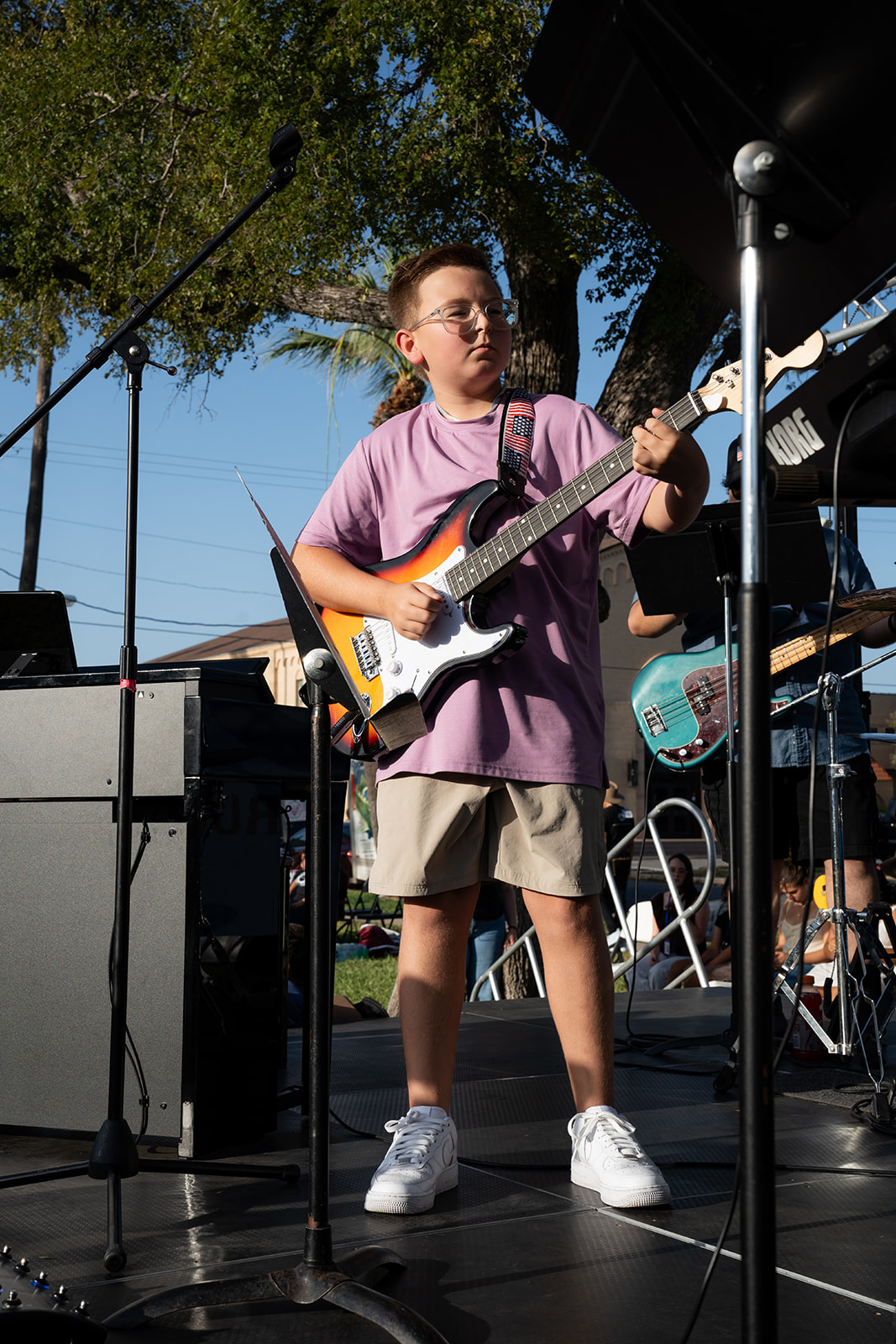 Young guitarist performing on the festival stage